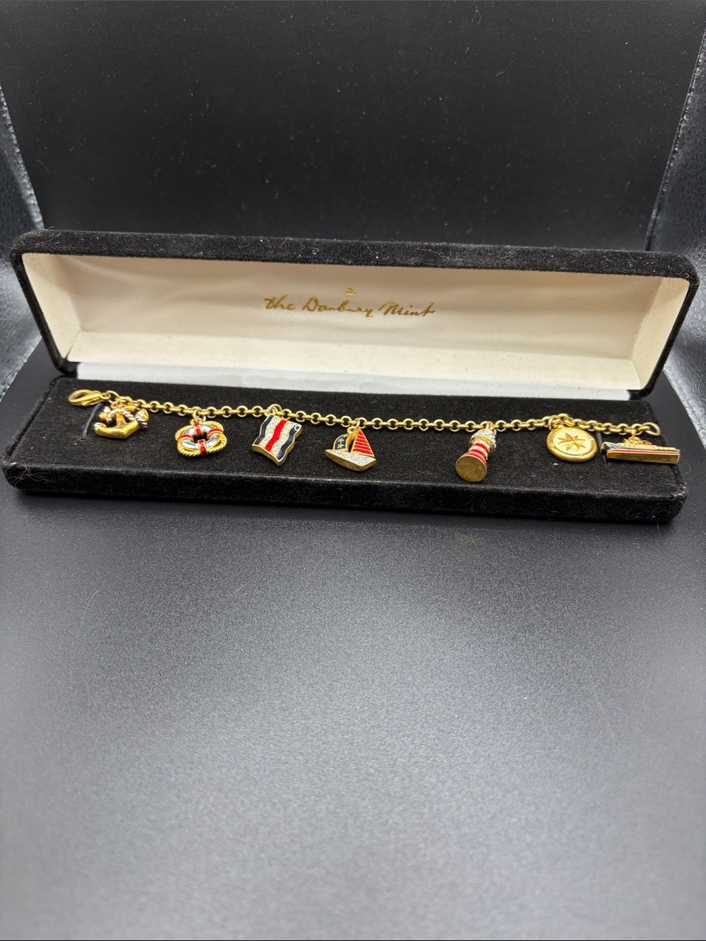 The Danbury Mint Nautical Charm Bracelet. Enamel and crystal. One missing charm.